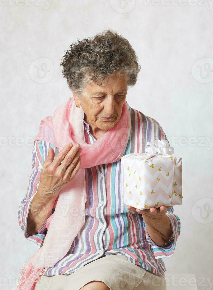 Old woman and a present photo