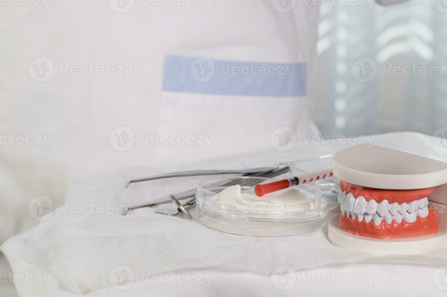 Sterile cotton napkins and stomatological tools on a table. Closeup photo