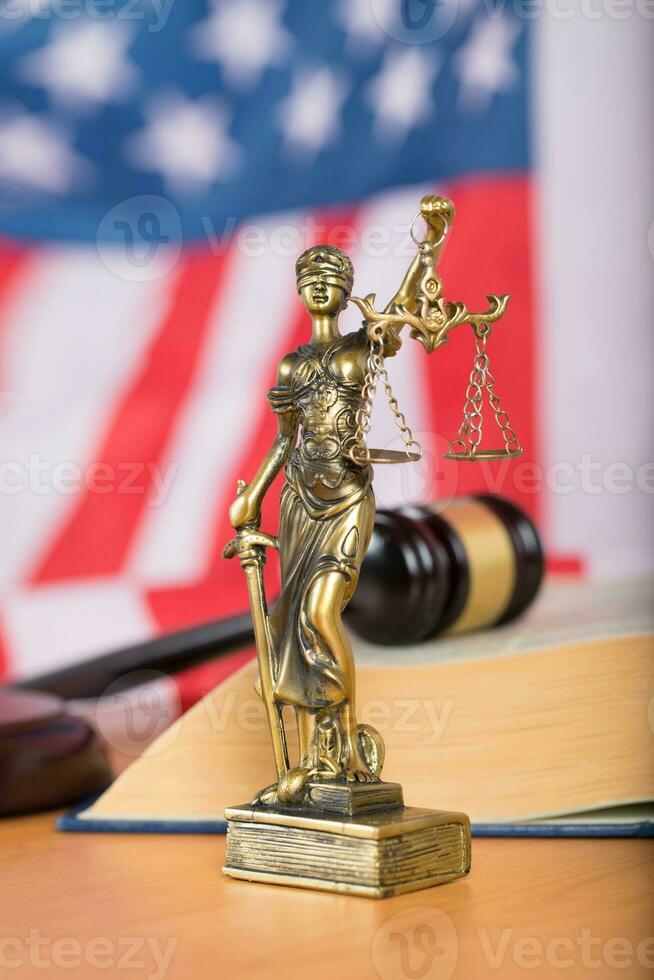 Statue of Themis and judge's gavel on a table. photo