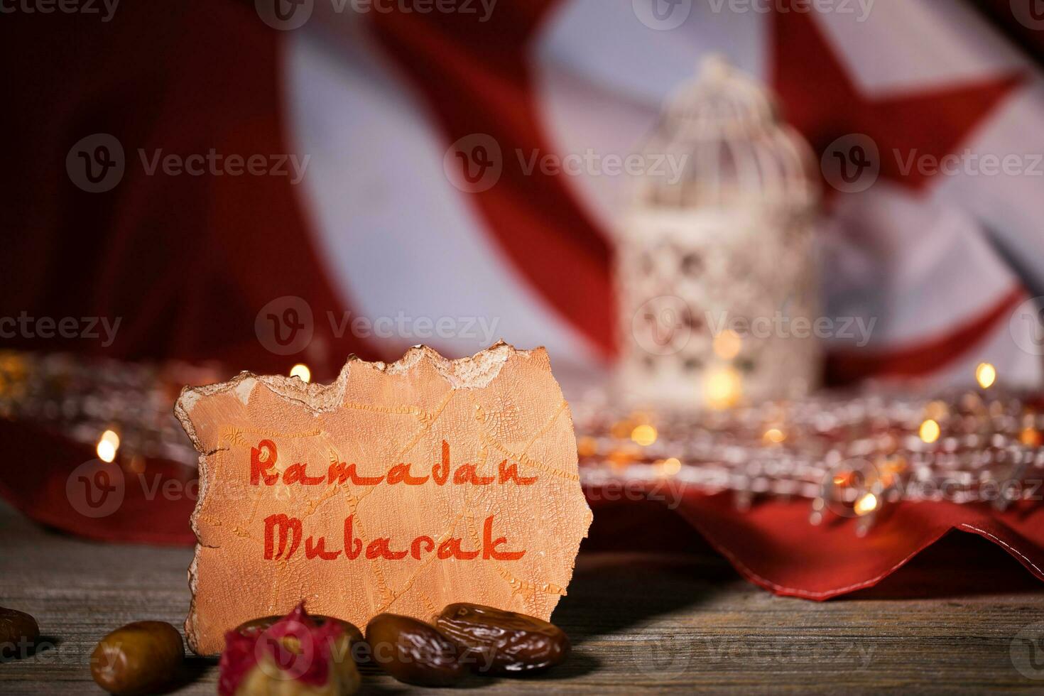 Ramadan Mubarak is written on a piece of paper. Ramadan background. photo