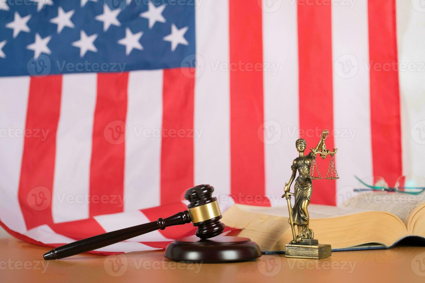 Statue of Themis and judge's gavel on a table. photo