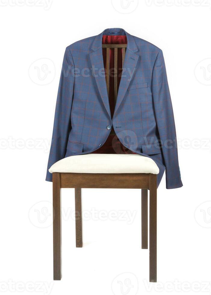 Male classical jacket is hanging on a chair. photo