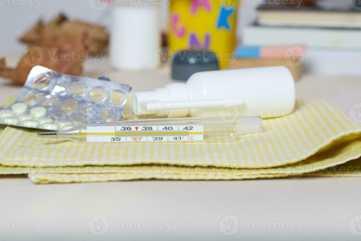 Mercury thermometer on a working table photo