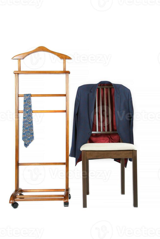 Classical tie on a jacket hanger stand and jacket is hanging on the chair. photo