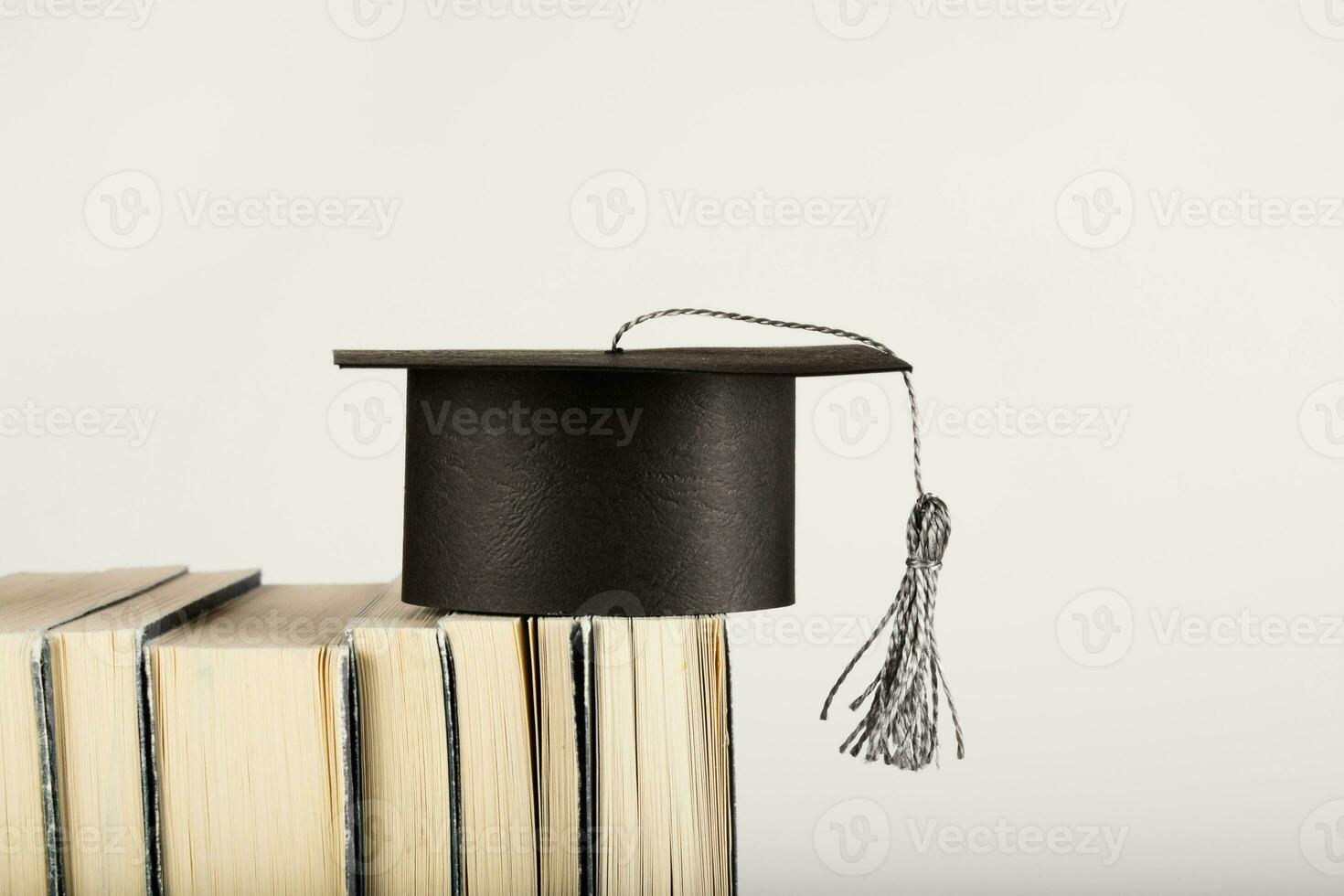 Academic hat on books. Free space for a text. photo