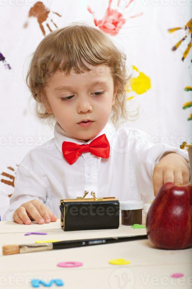 Boy of four years is playing with letters. photo