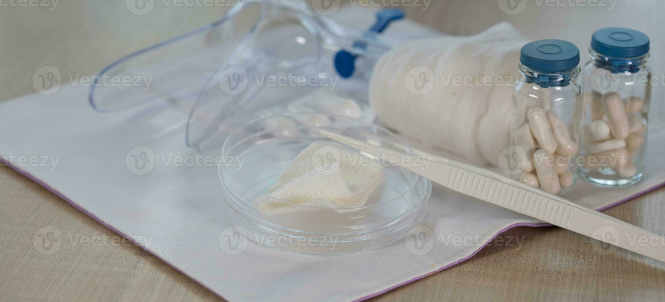 Sterile cotton napkin and pincette on a table. photo