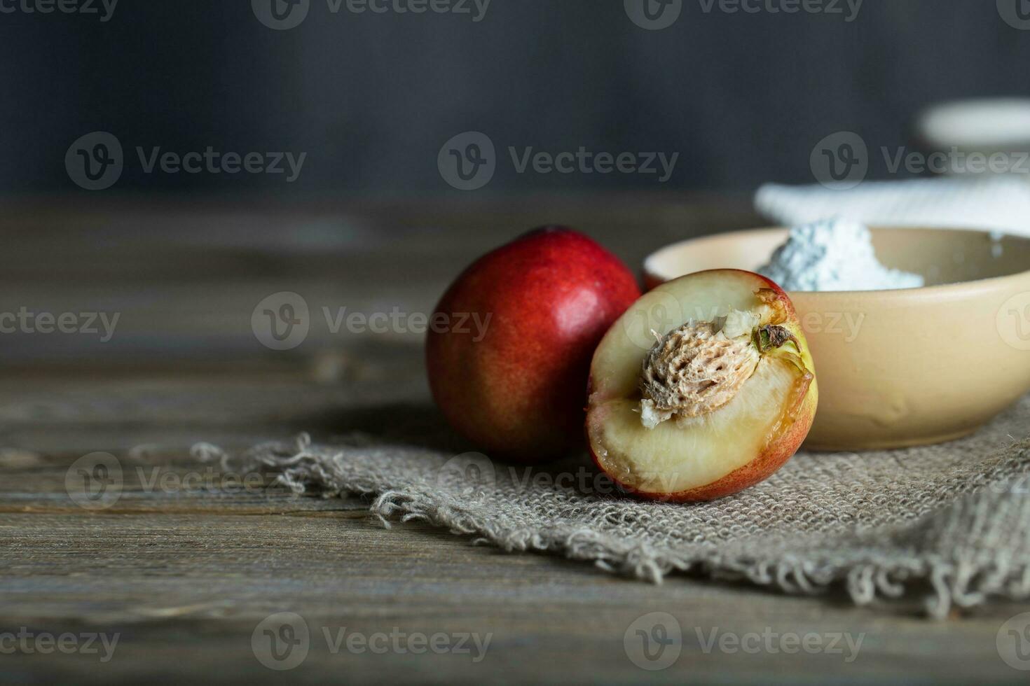 Peach seeds facial mask in a clay pot. photo