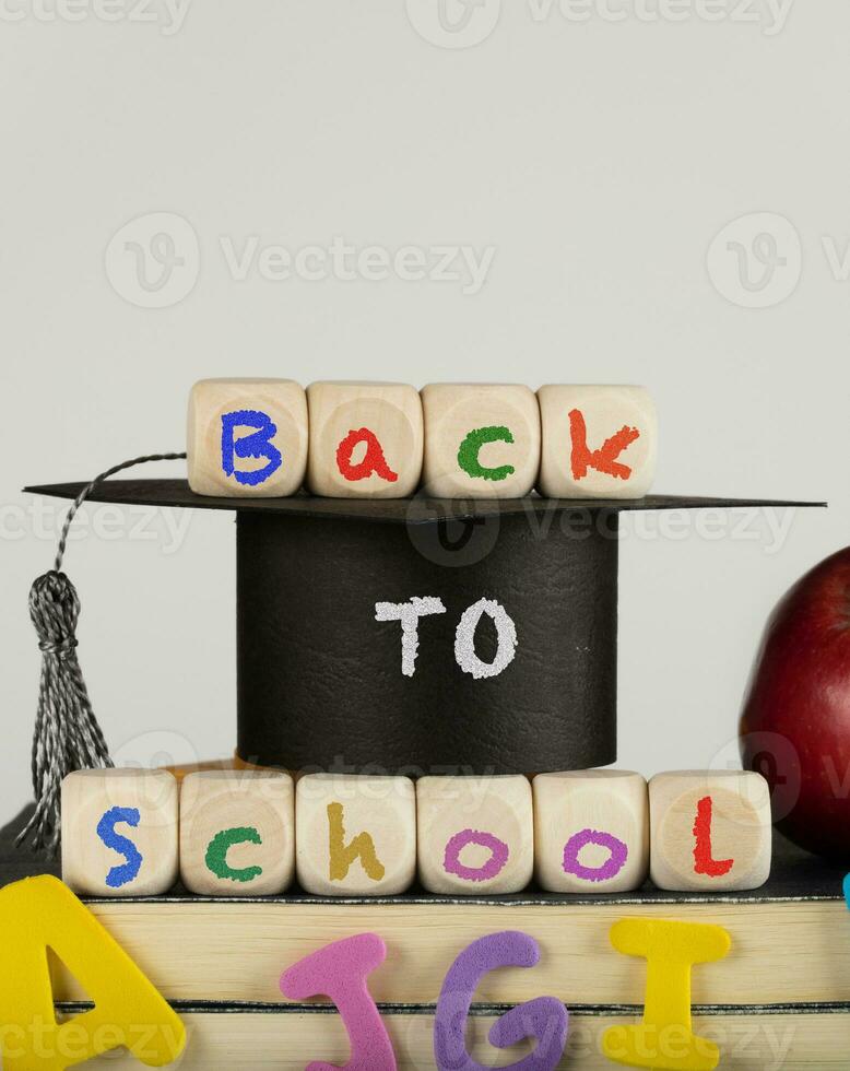 Words BACK TO SCHOOL composed of wooden dices. photo