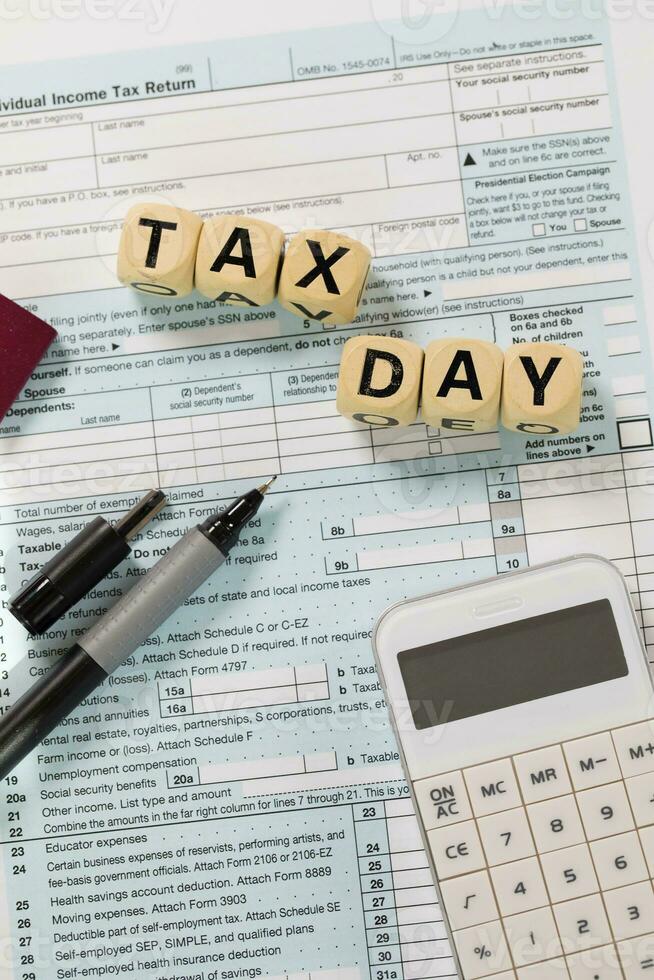 Word Tax Day composed of wooden letters. Closeup photo