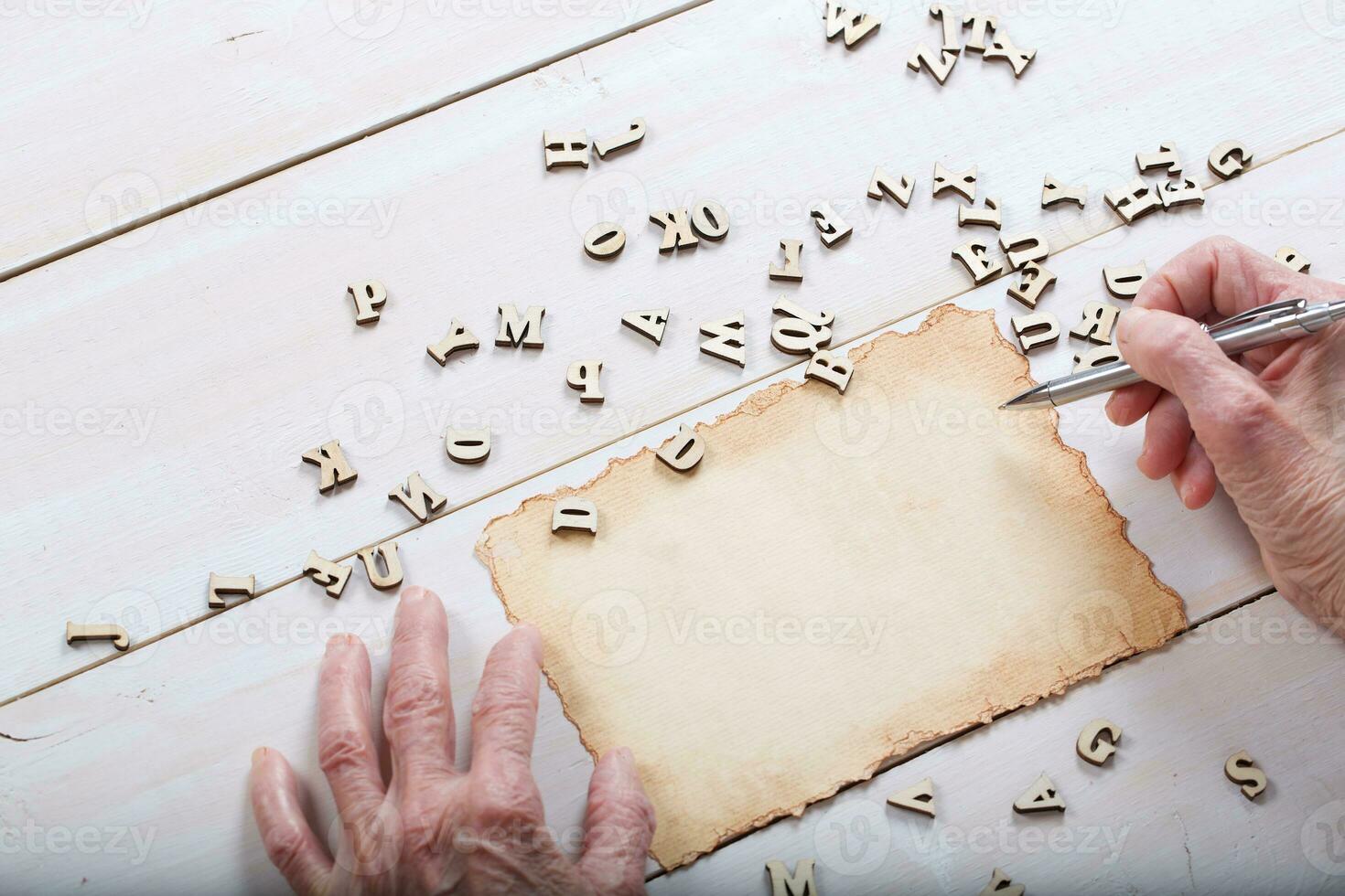 Old woman writes something. photo