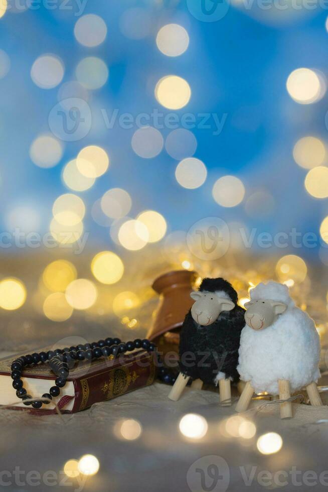 Festival of Sacrifice background.Quran, beads for praying, small tagine and two lambs photo