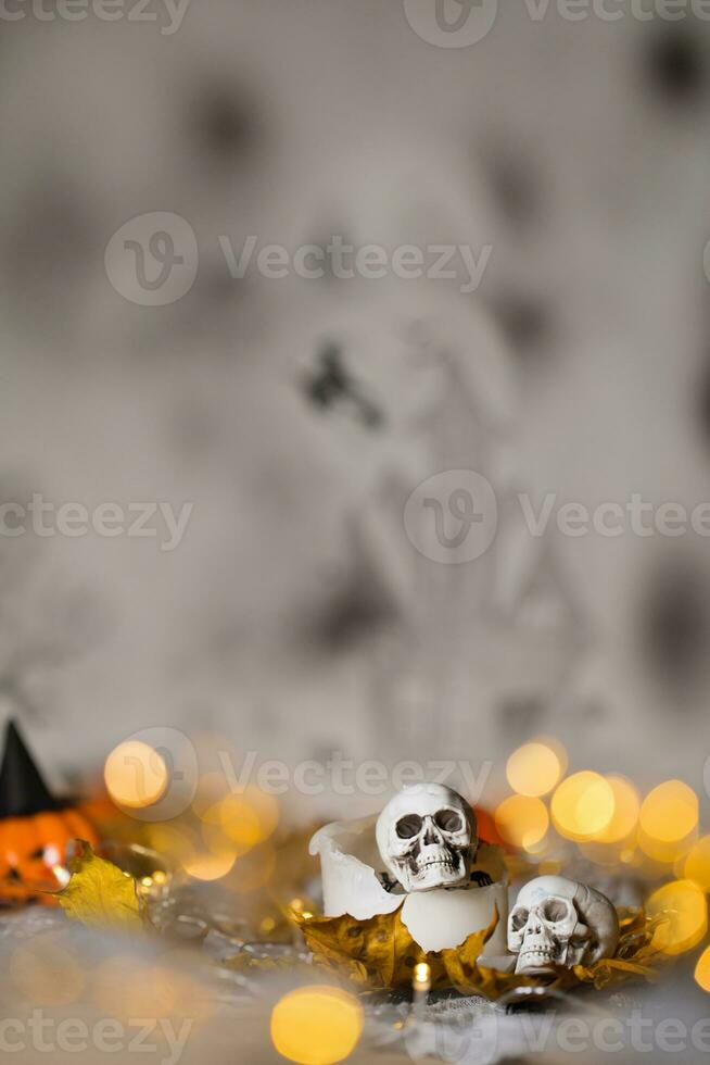 Skull on an old used thick candle. Scary Halloween background. photo
