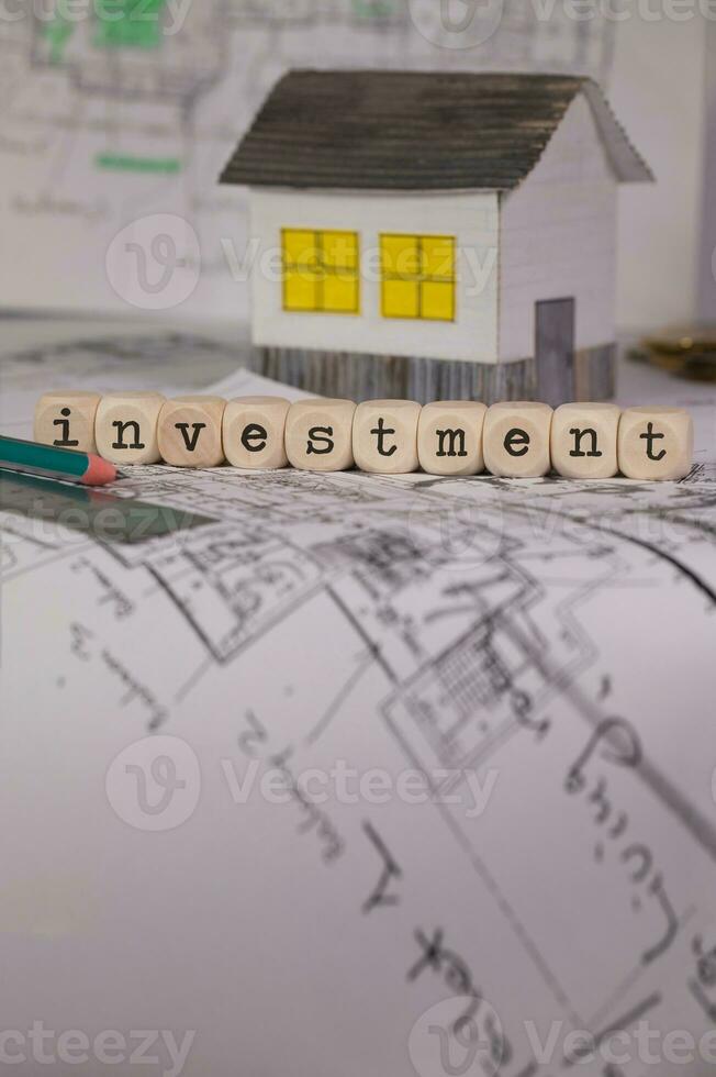 Word INVESTMENT composed of wooden letters. Closeup photo