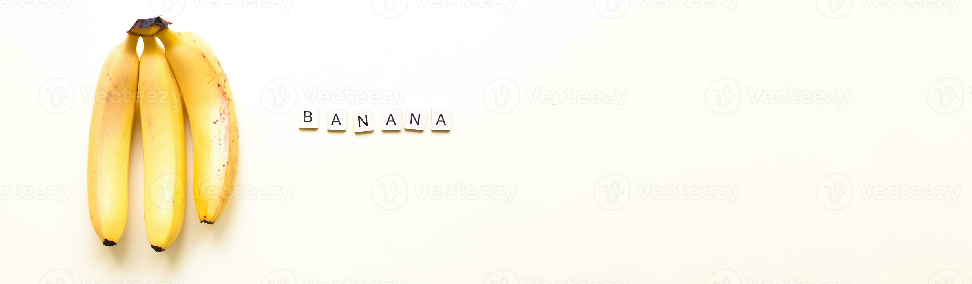 Banner Flatly bananas. The word bananas from wooden letters. Veganism, fruitarianism photo