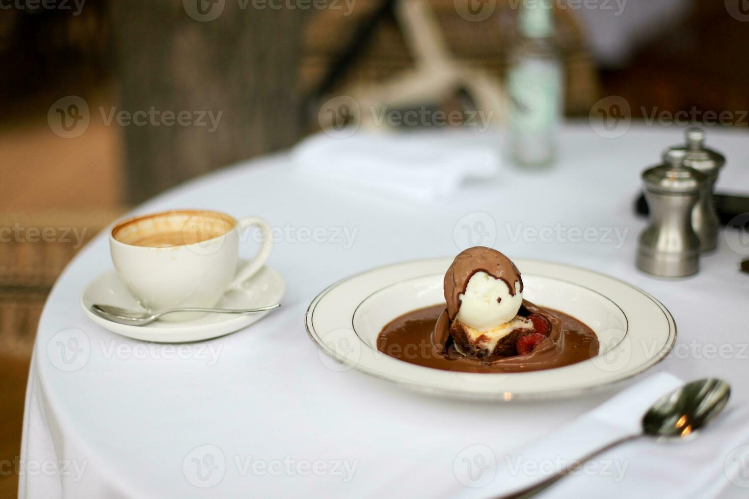 Dessert and coffee. Brownie with ice cream and chocolate sauce photo