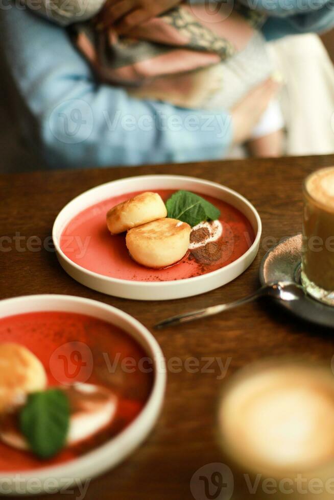 Dessert in a cafe. Cheesecakes with berries. Breakfast with a child photo