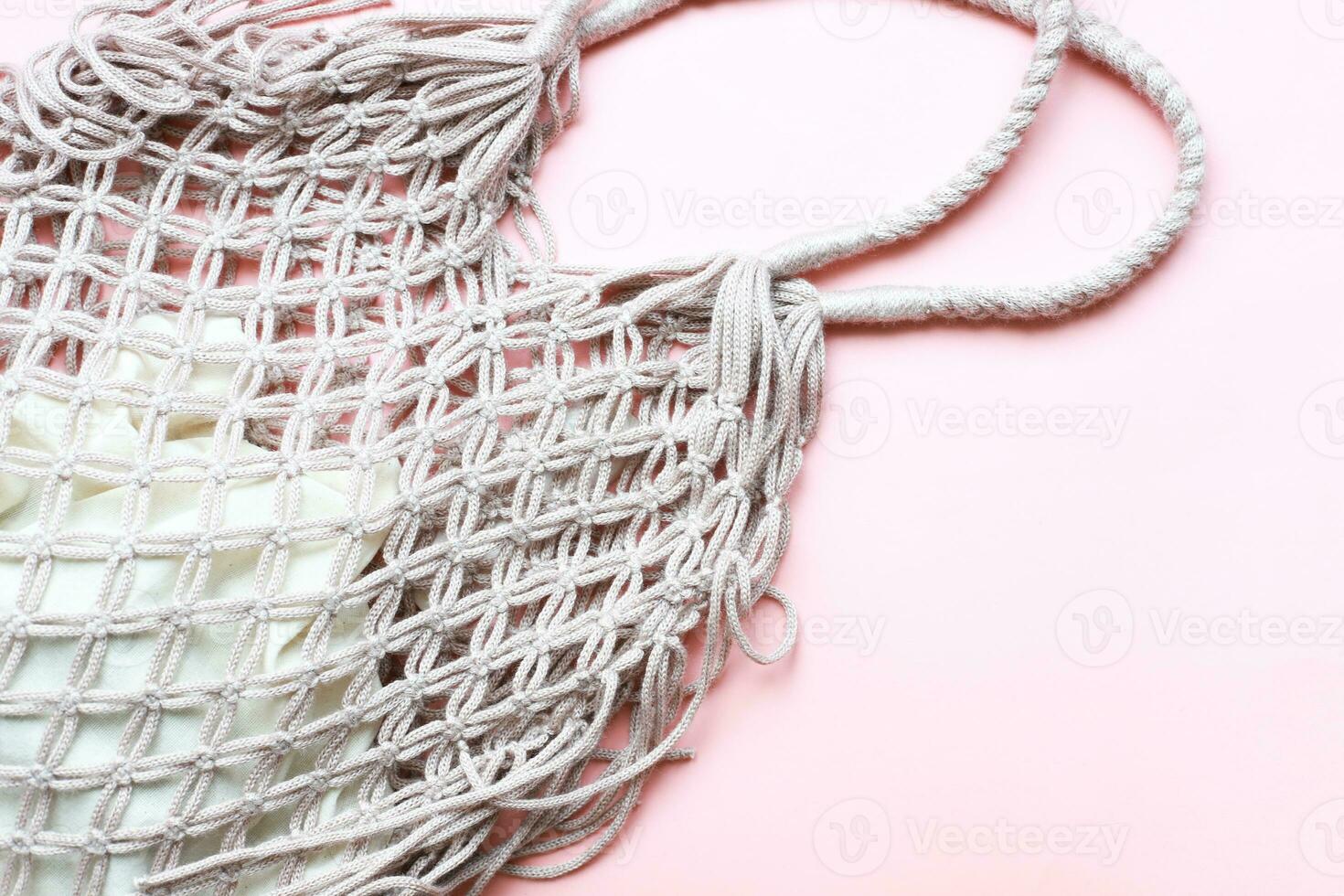 Flat lay mesh bag on pink background. Zero waste. Ecology, rejection of plastic photo