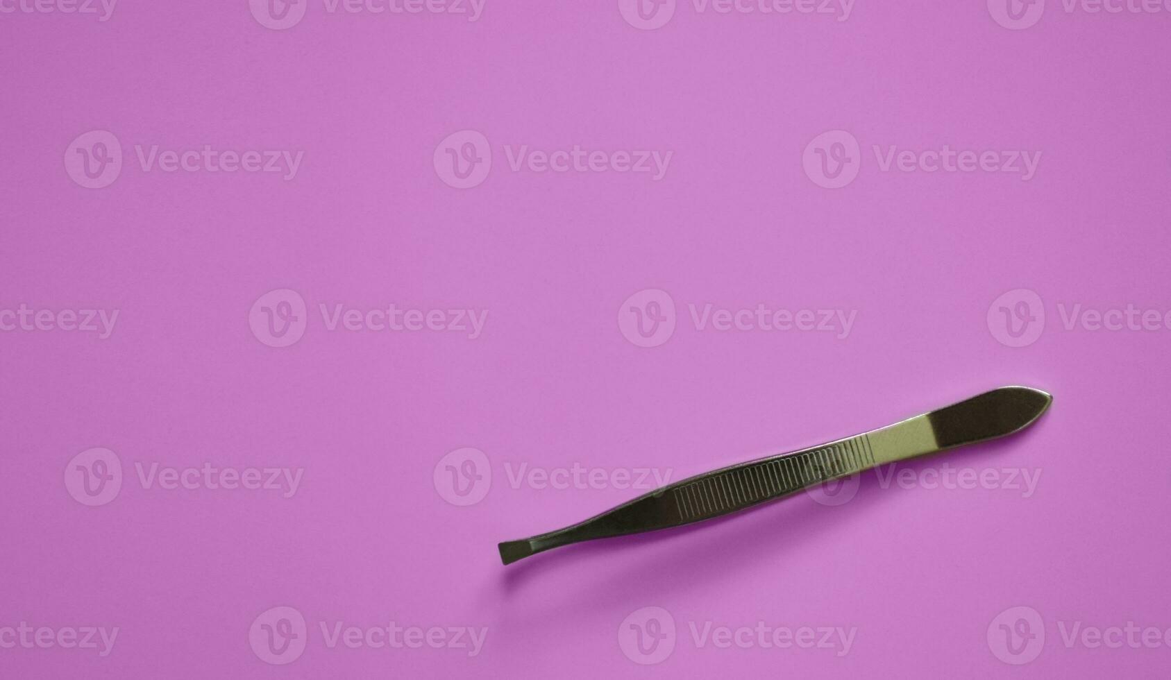 tweezers on a pink background, modeling, decoration and lamination of eyebrows, medical tweezers, a place for text photo