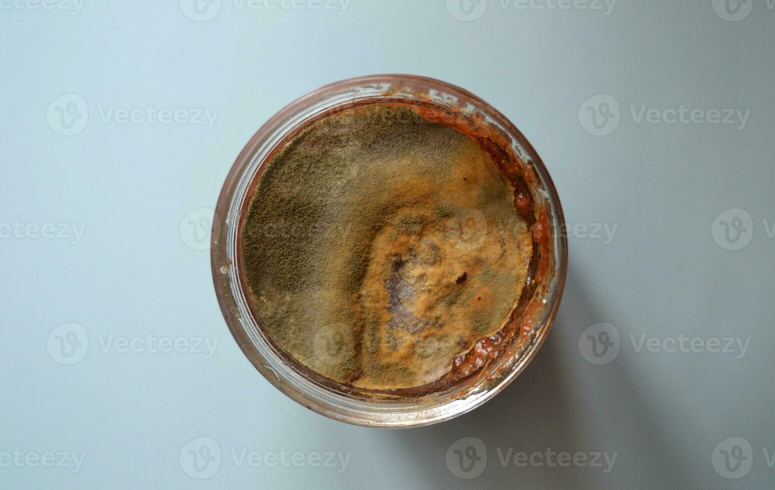 mold on raspberry jam, spoiled foods, mold jar, violation of cooking technology, health hazard, canned foods, top view photo