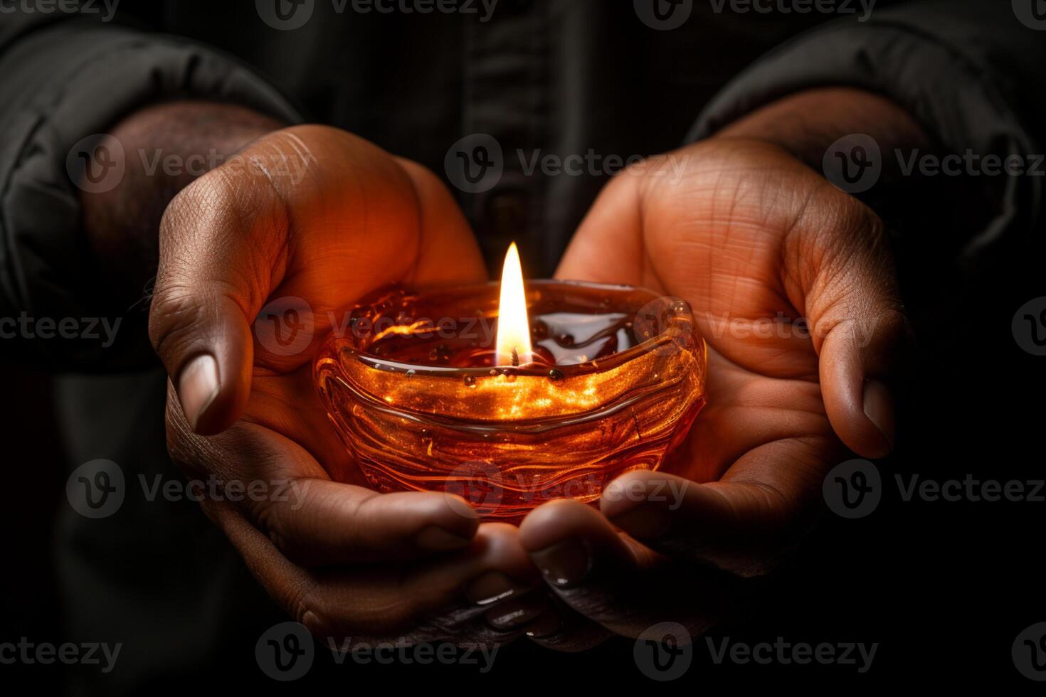 Embracing darkness, hands cradle the warm glow of candlelight photo
