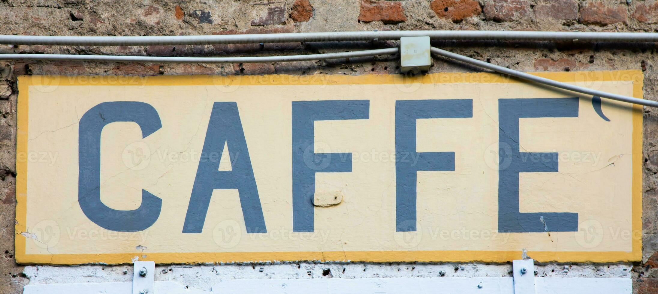 Old vintage coffee sign in Italy - Concept of retro, traditional design. photo