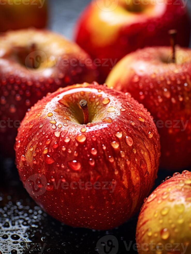 Fresh red apples with water drops on black background. Shallow dof. photo