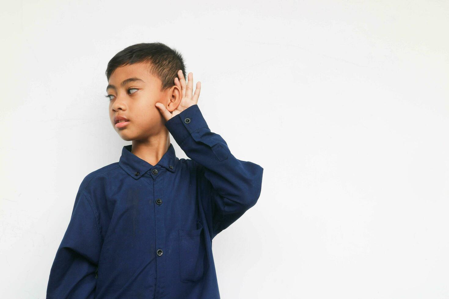 Kid in blue shirt listening something photo