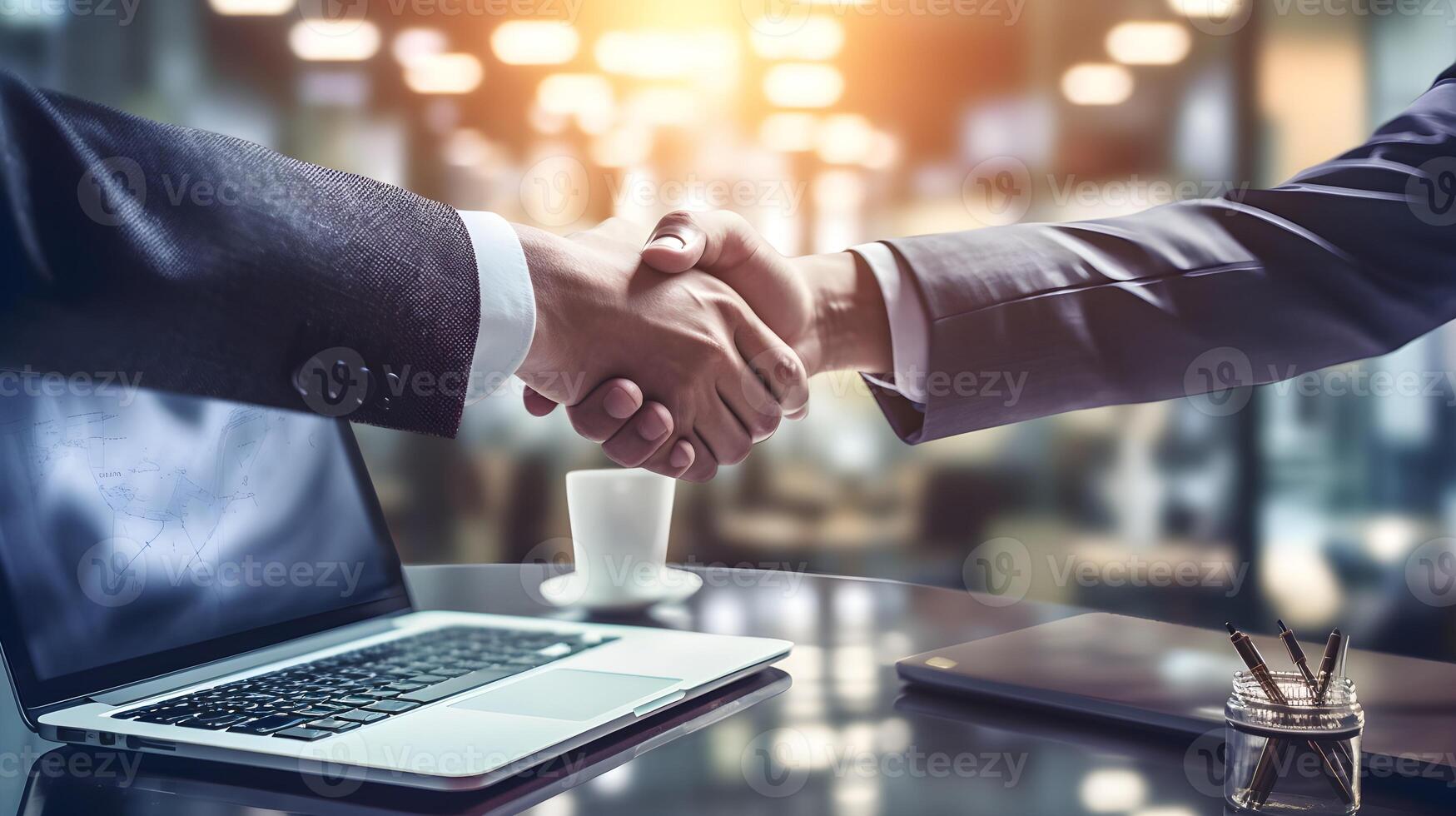 cooperation, recruitment between two people shaking hands with laptops at the table photo
