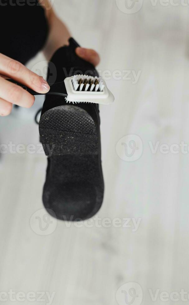 hands wipe black leather boot photo