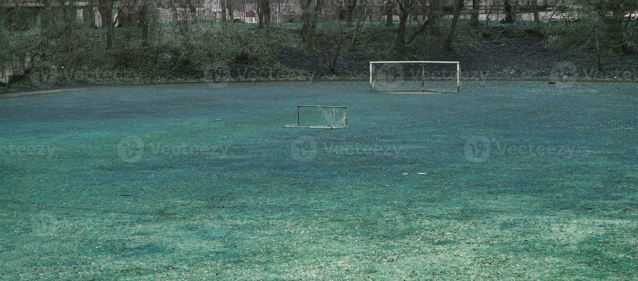 Abandoned football field in rustic area photo