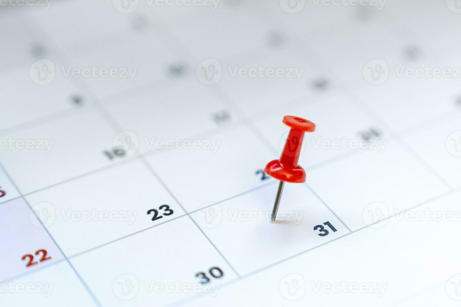 Red push pin on calendar 31st day of the month, new year eve photo