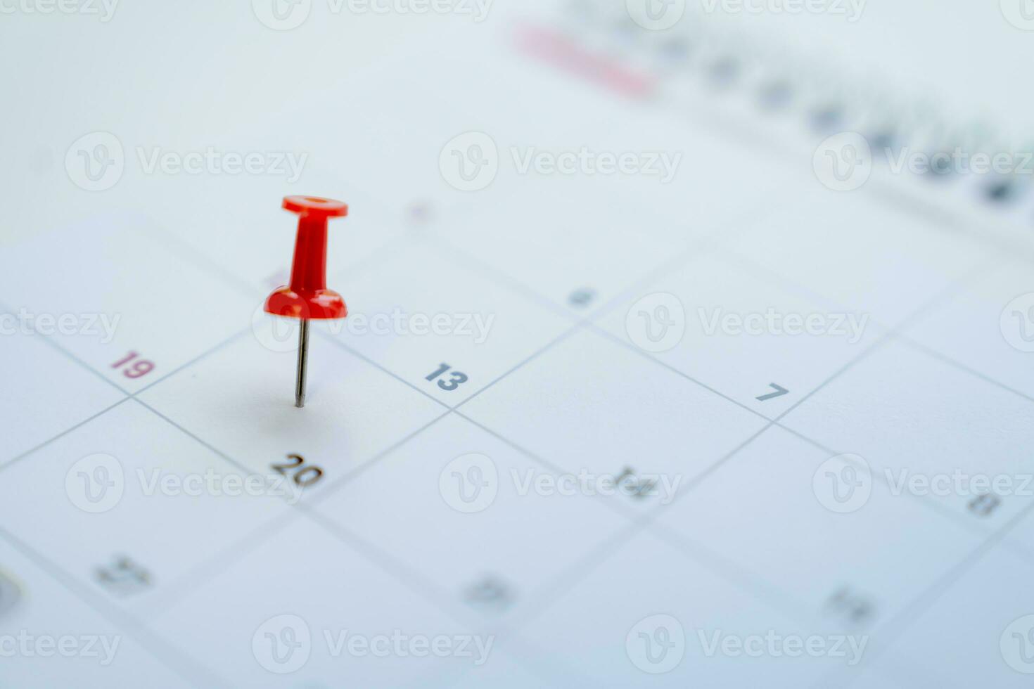 Close-up view of red pins with calendar for event planner event photo