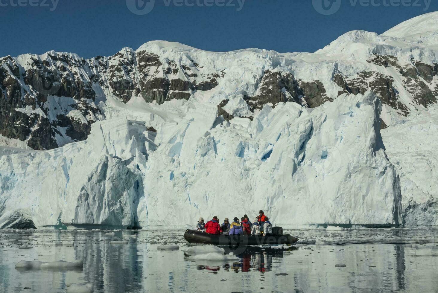 Tourists observing a glacier on the Antarctica, Paradise bay, Antartic Peninsula. photo