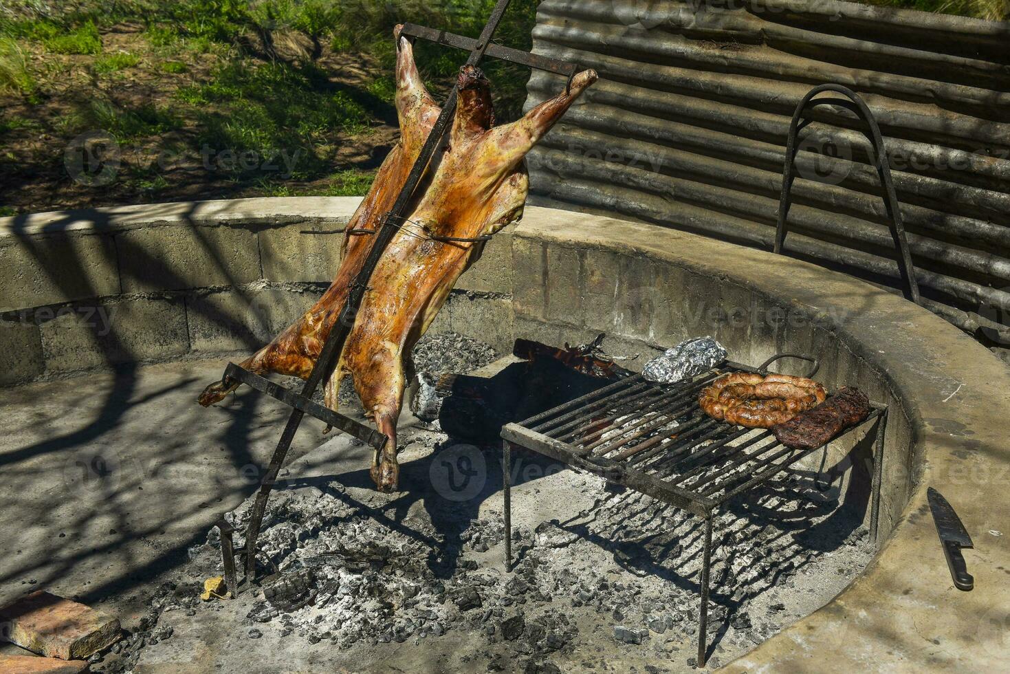 Lamb on the spit, cooked with the traditional Argentine method, La Pampa province, Patagonia, Argentina. photo