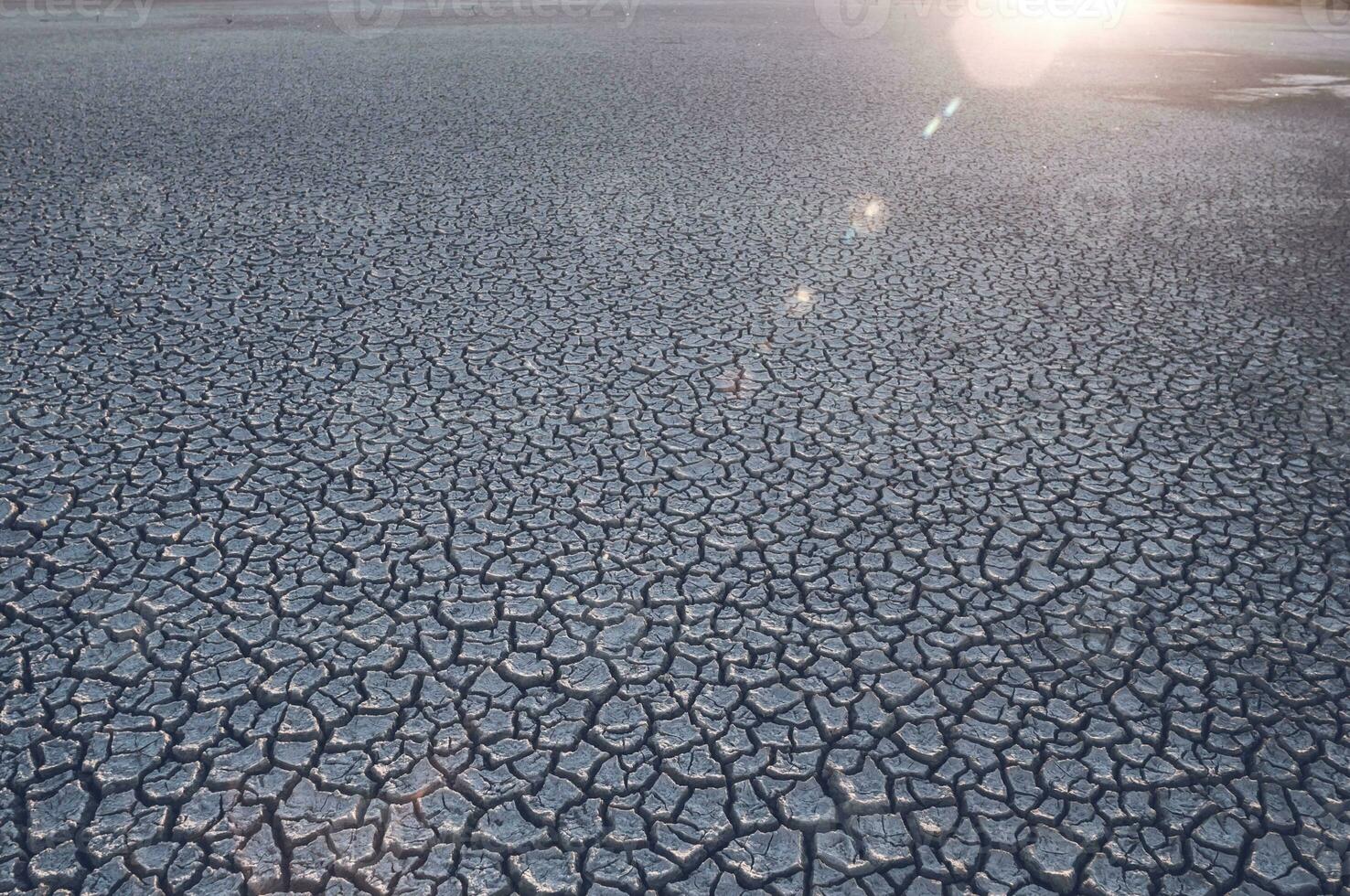 Cracked earth, desertification process,abstract background photo