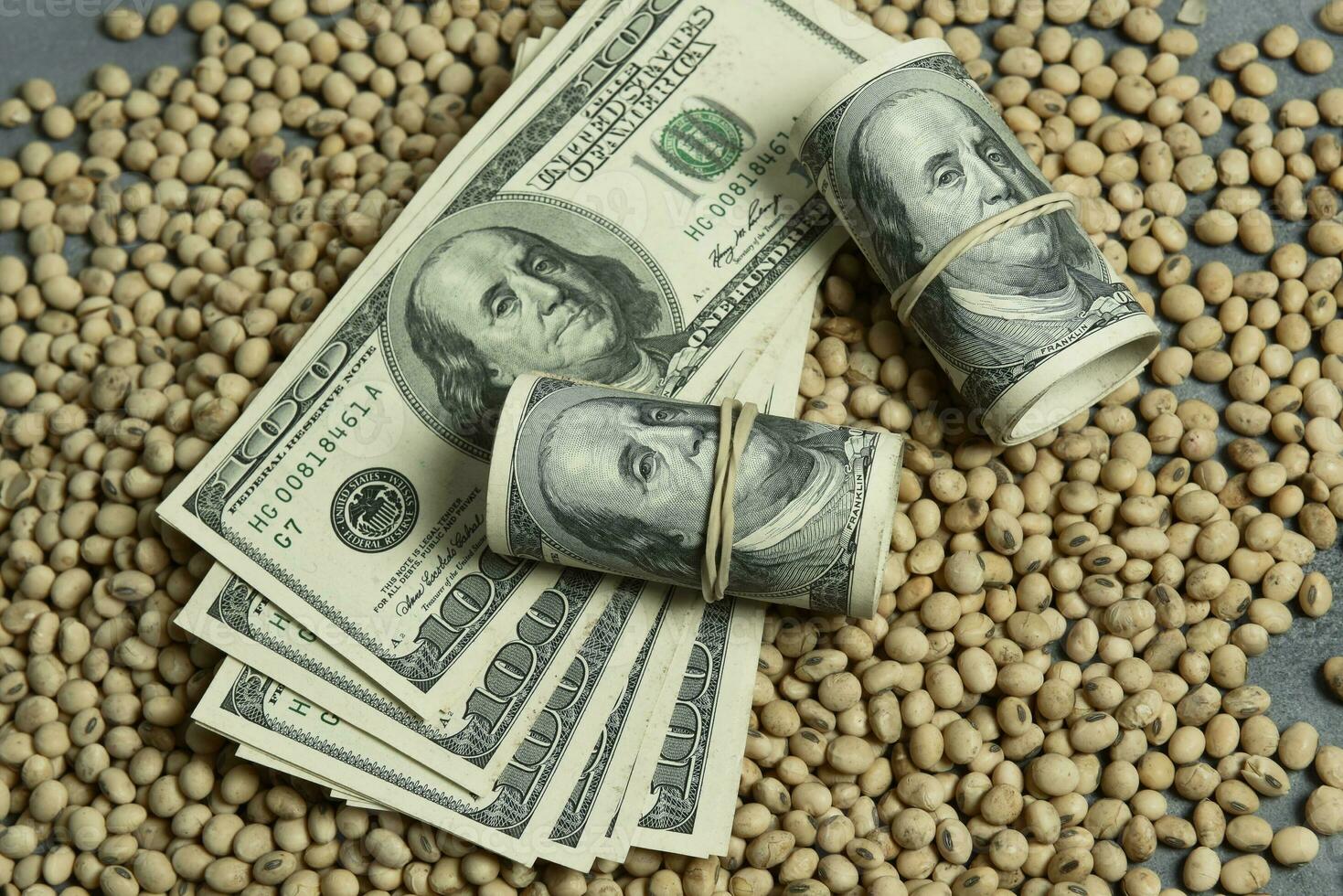 Dollars banknotes and coins and soy beans,oleaginous commoditi value concept. photo