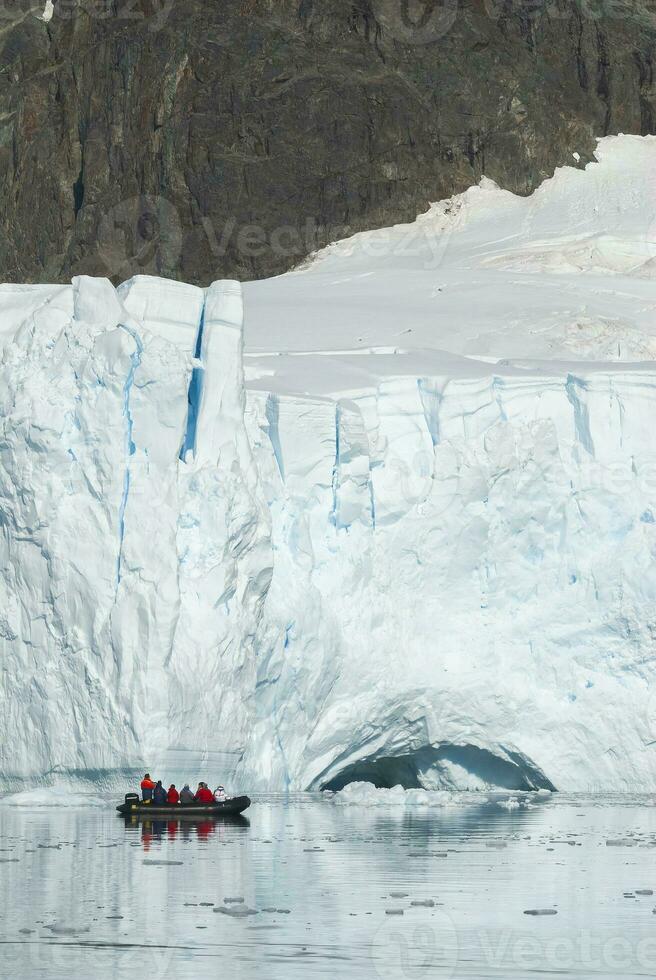 Tourists observing a glacier on the Antarctica, Paradise bay, Antartic Peninsula. photo