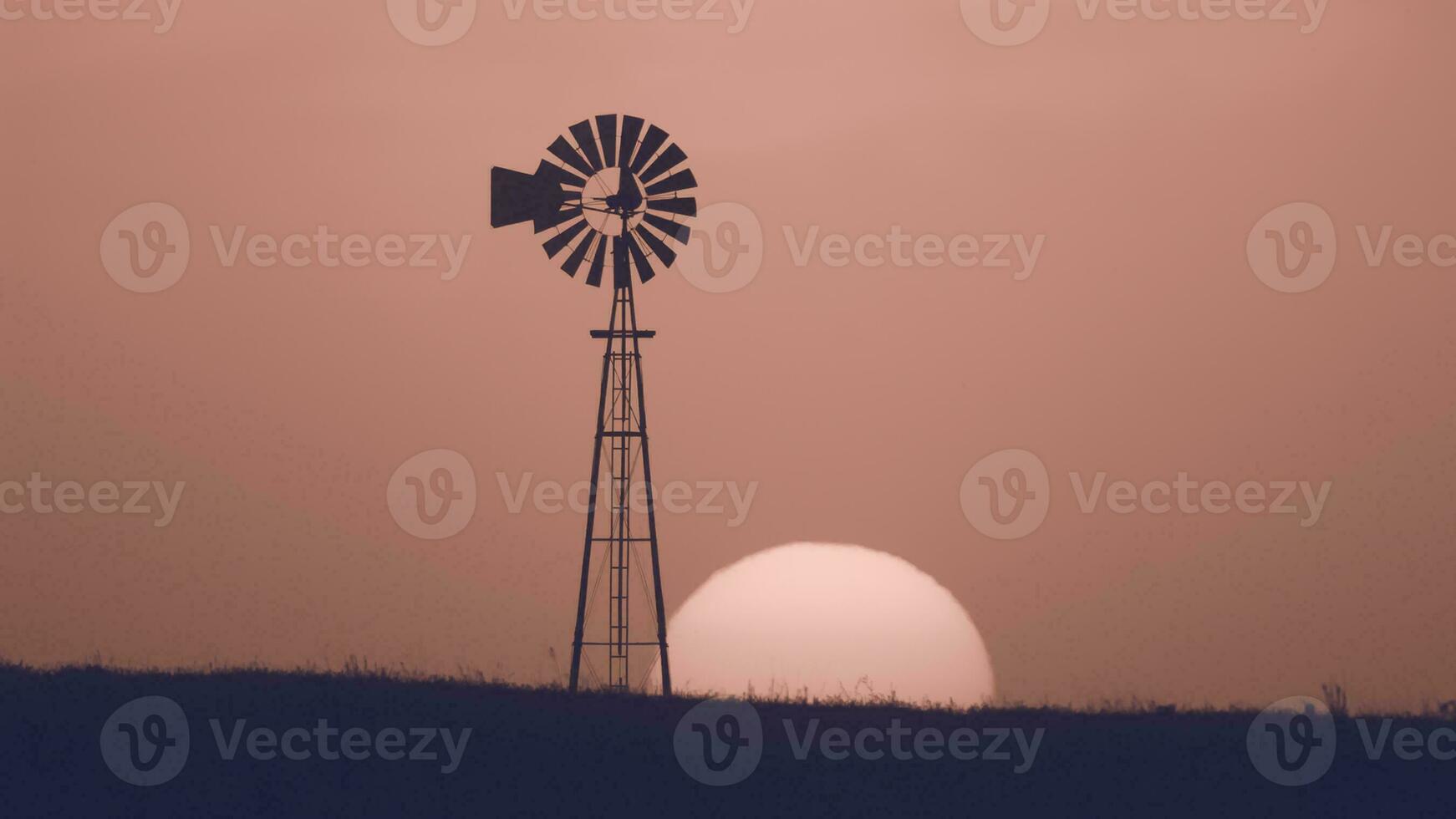 Windmill in countryside at sunset, Pampas, Patagonia,Argentina. photo