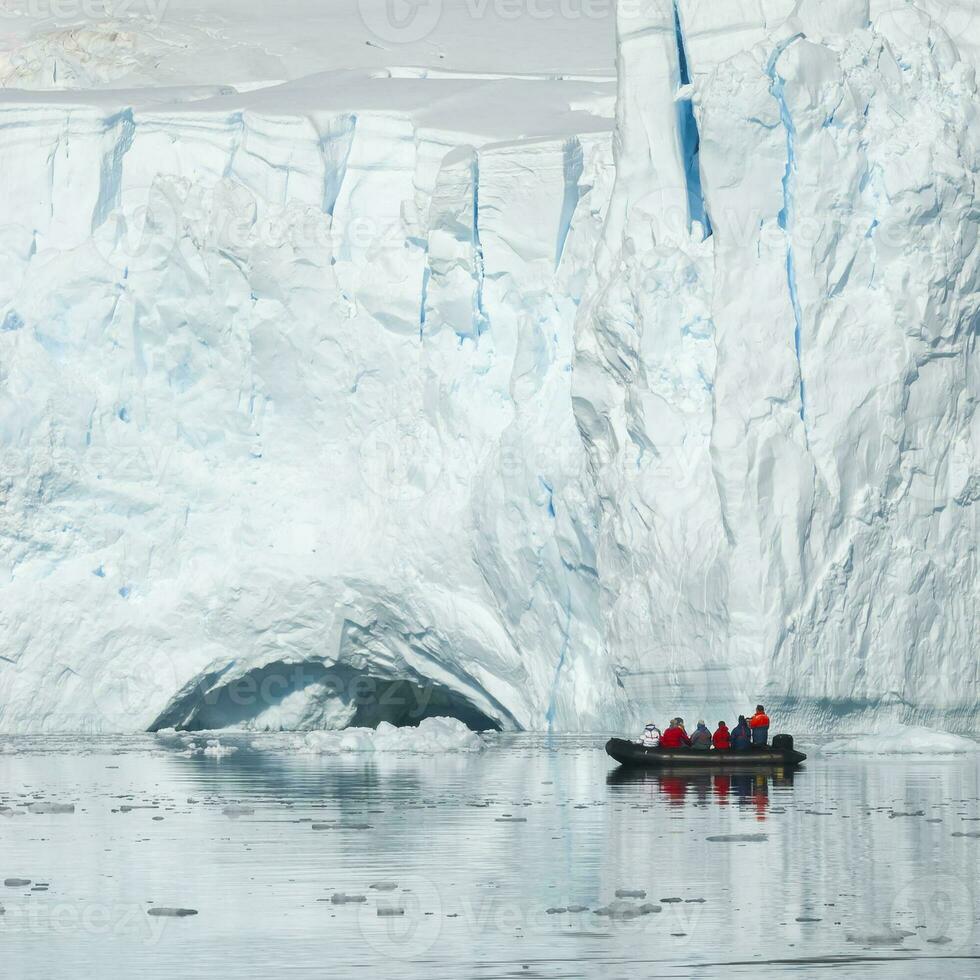 Tourists observing a glacier on the Antarctica, Paradise bay, Antartic Peninsula. photo