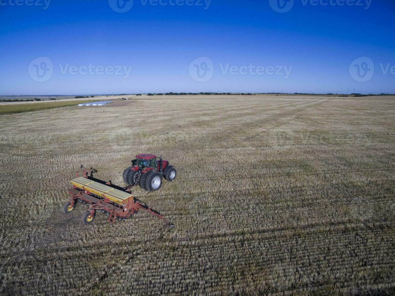 Tractor and seeder, direct sowing in the pampa, Argentina photo