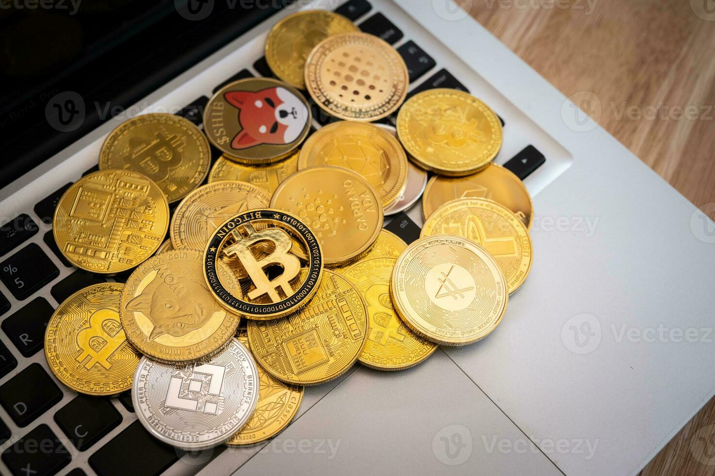 Various kinds of cryptocurrency token coins on laptop keyboard. Cryptocurrency is a digital or virtual currency that is secured by cryptography. photo