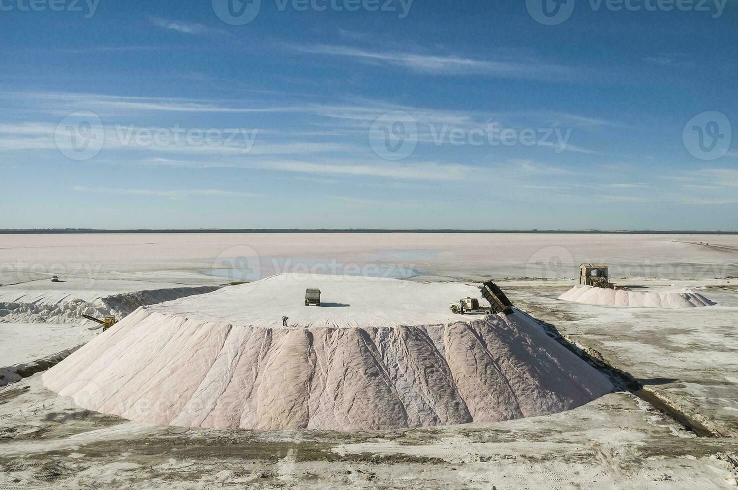 Trucks unloading raw salt bulk, Salinas Grandes de Hidalgo, La Pampa, Argentina. photo
