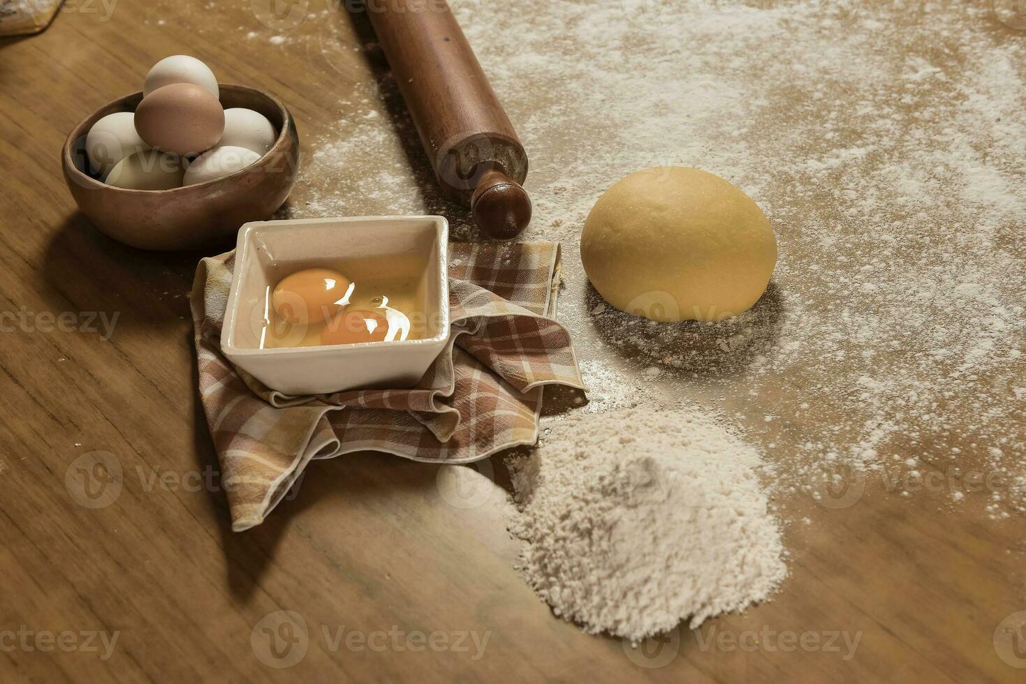 Egg dough for noodles, with ingredients on the table, traditional italian cuisine. photo