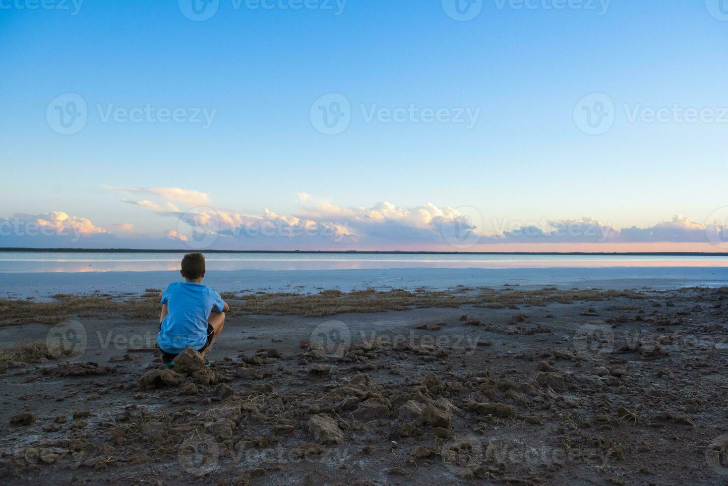 Boy contemplate the horizon, La Pampa Province, Argentina photo