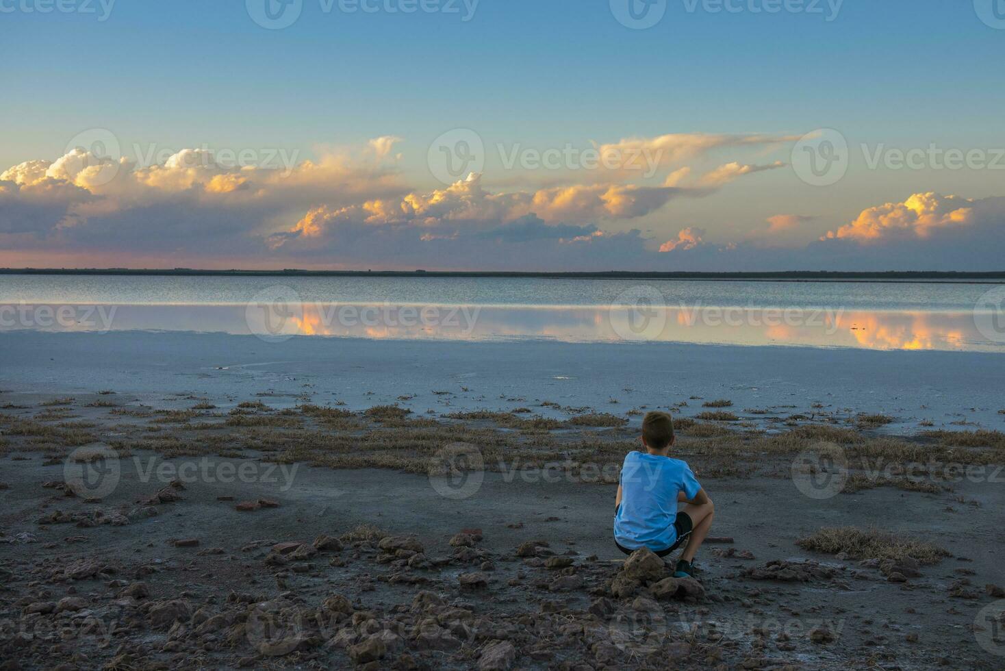 Boy contemplate the horizon, La Pampa Province, Argentina photo