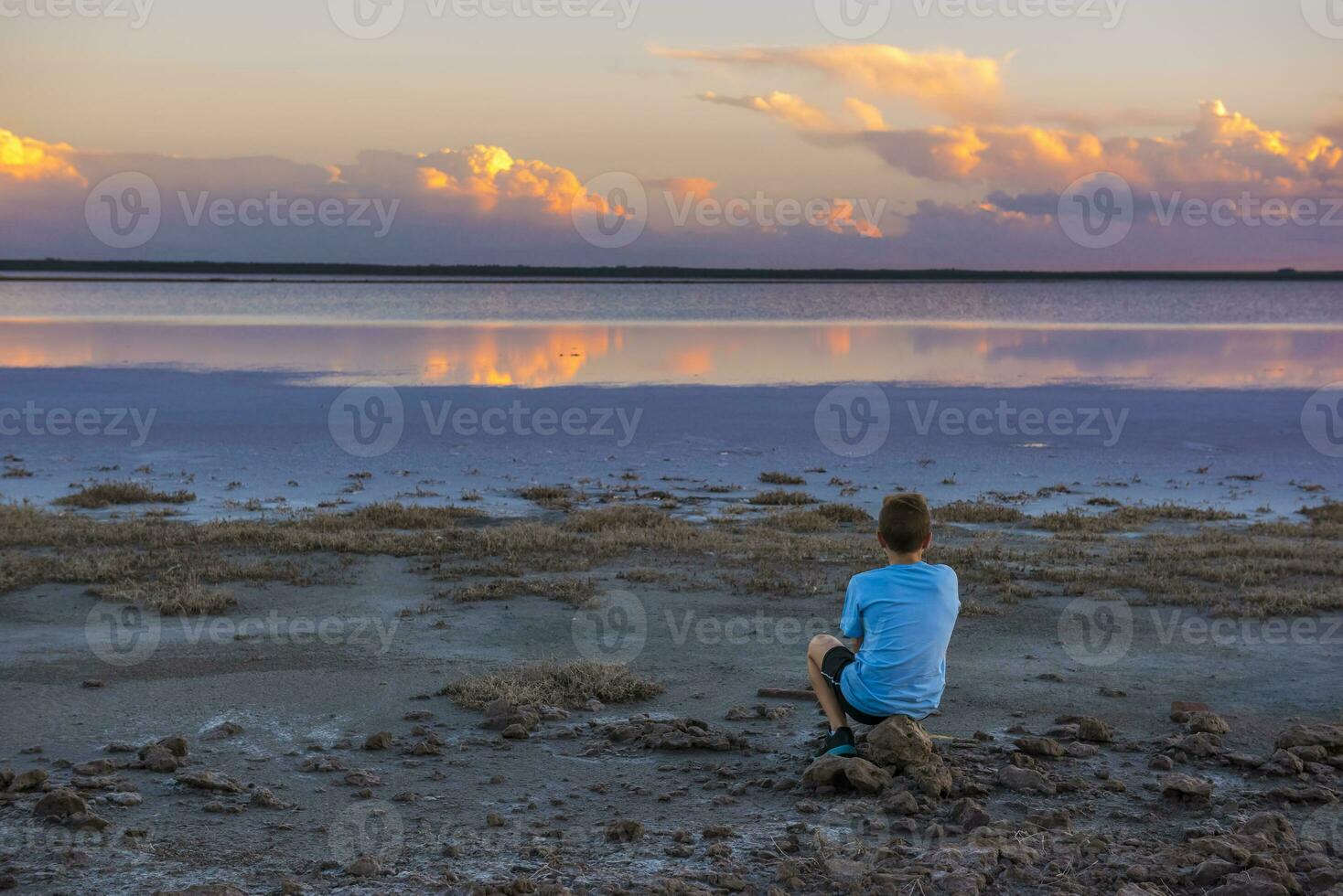 Boy contemplate the horizon, La Pampa Province, Argentina photo