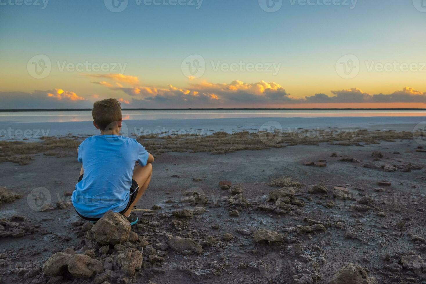 Boy contemplate the horizon, La Pampa Province, Argentina photo