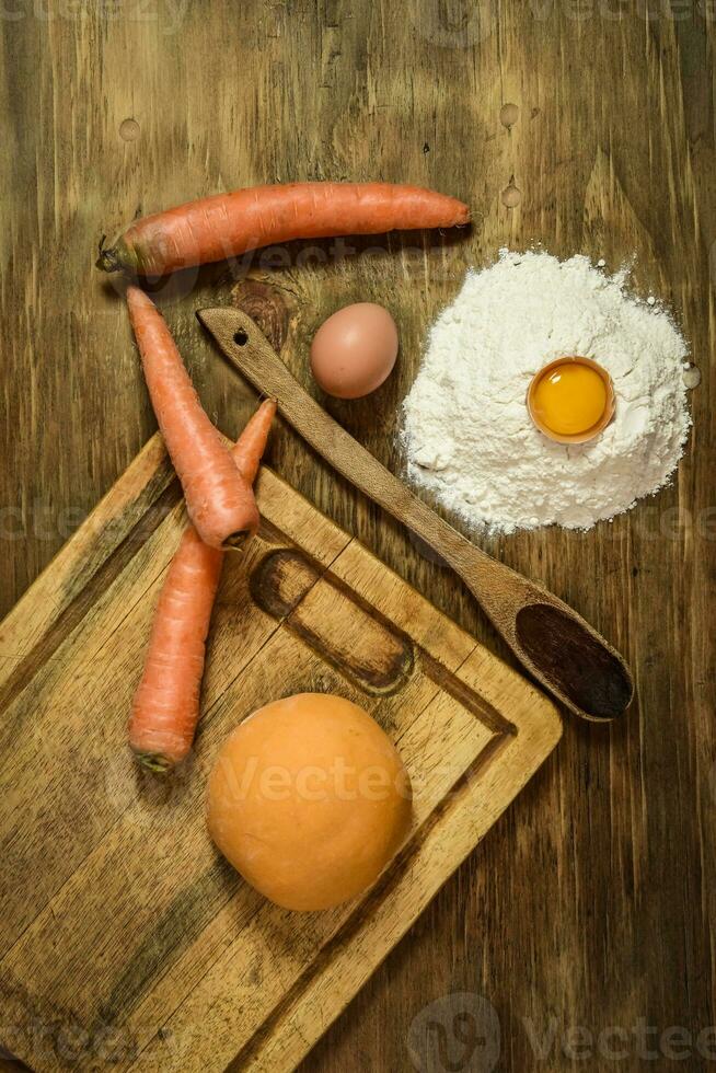 Orange dough bun for noodles with ingredients on the table. photo