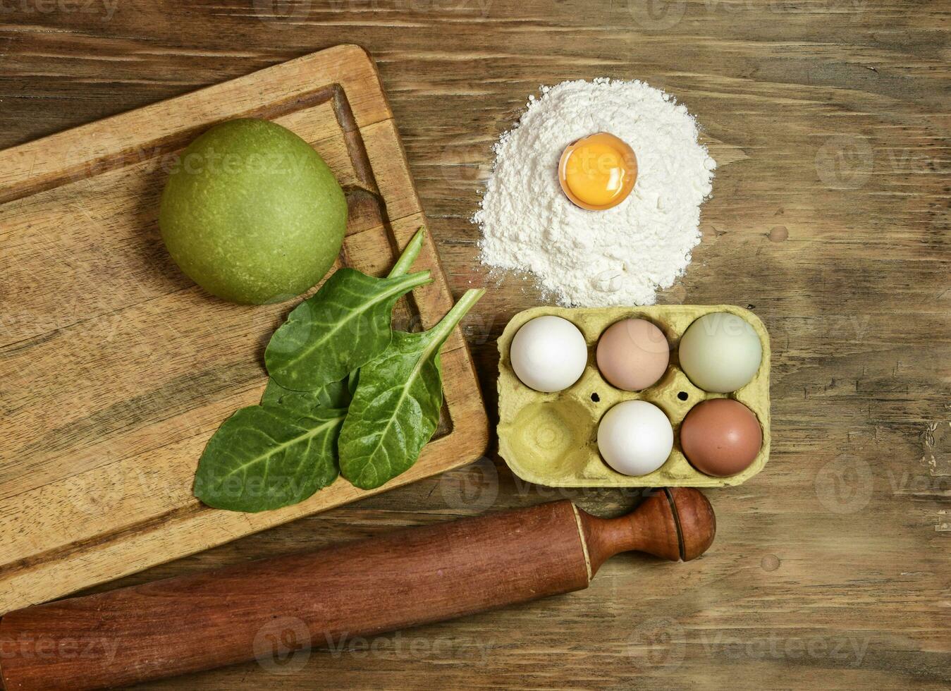 Green noodle dough bun, with ingredients on the table. photo